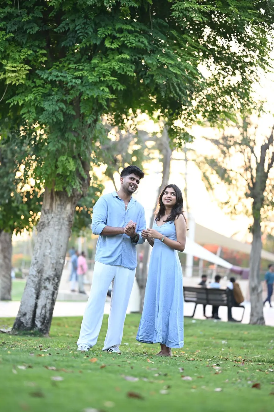 Unni and Hridya standing together under the trees