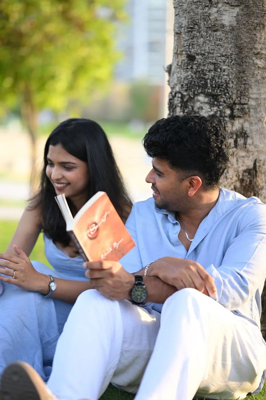 Reading a book together on the grass
