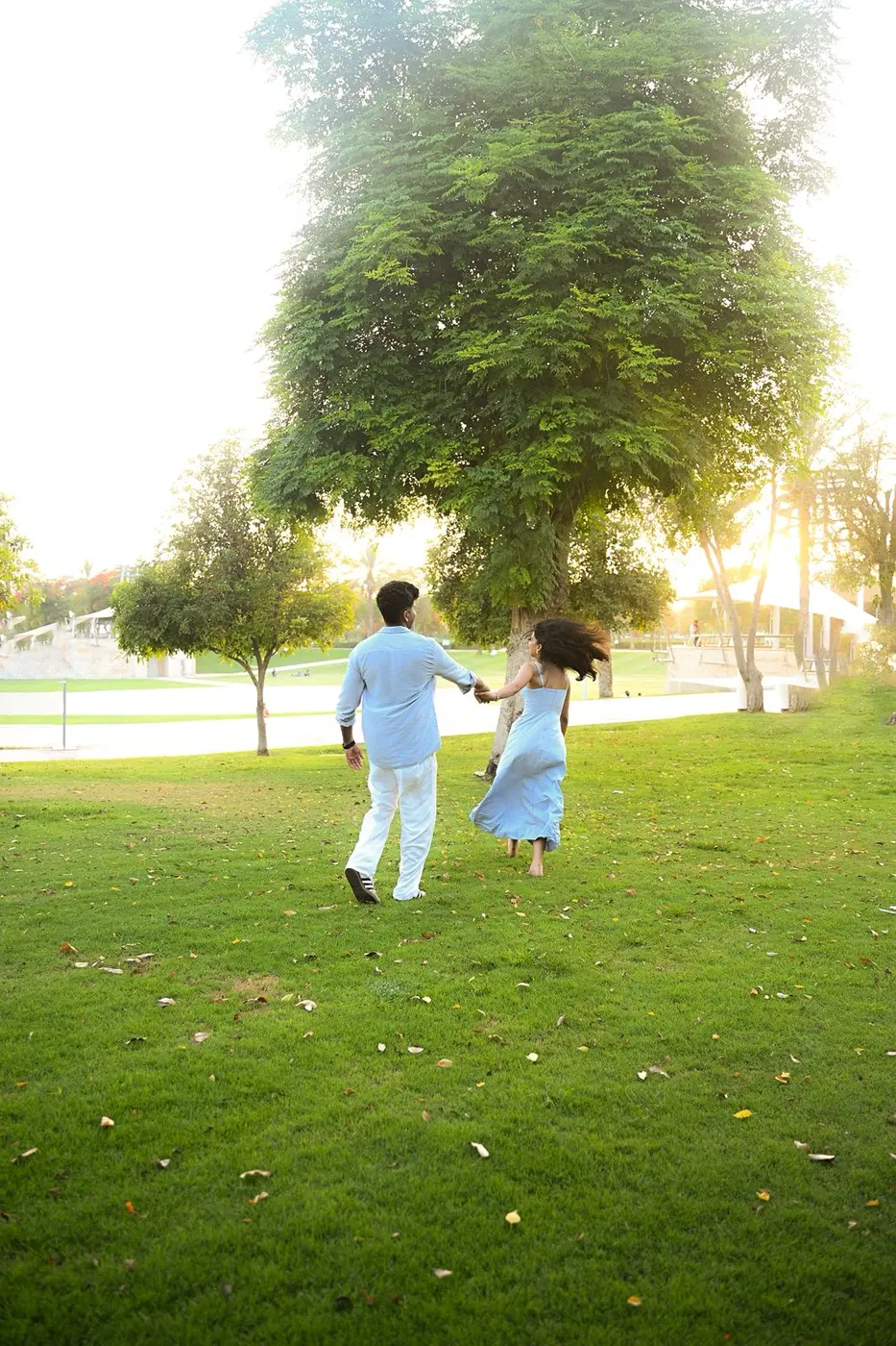 Running across the lawn towards the big tree